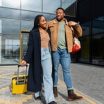 Two couples walking with their traveling bags